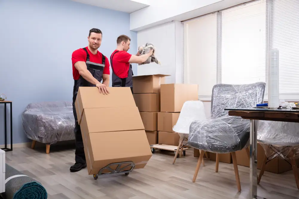 A well-organized office space with movers efficiently packing and moving items, representing an efficient office moving process